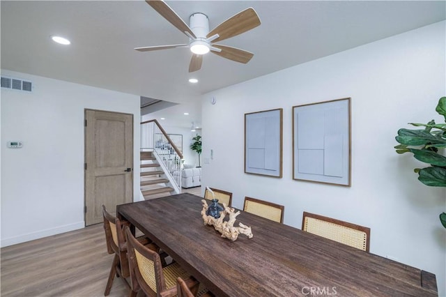 dining room with ceiling fan and light wood-type flooring