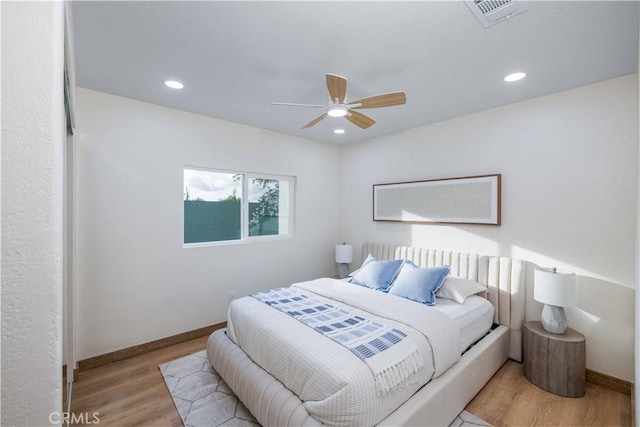 bedroom with light wood-type flooring and ceiling fan