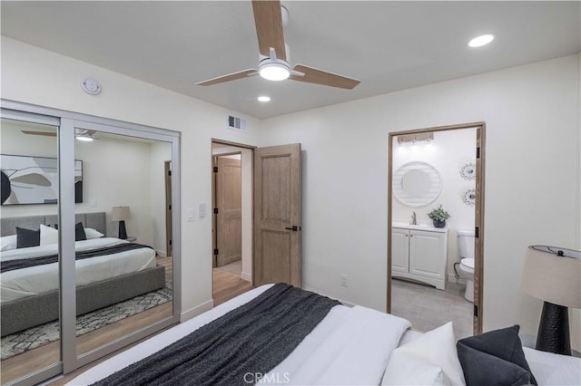 bedroom with ensuite bath and ceiling fan