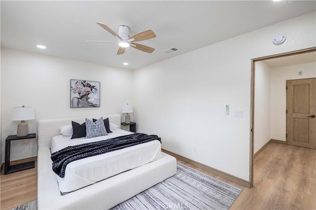 bedroom featuring ceiling fan and light hardwood / wood-style flooring