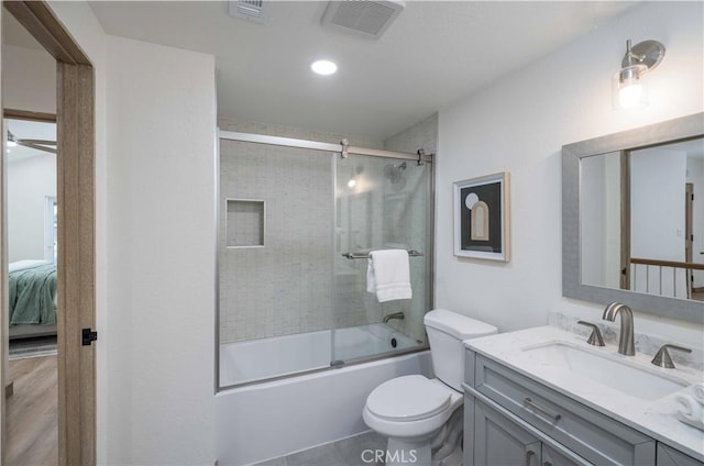 full bathroom with vanity, tile patterned flooring, shower / bath combination with glass door, and toilet