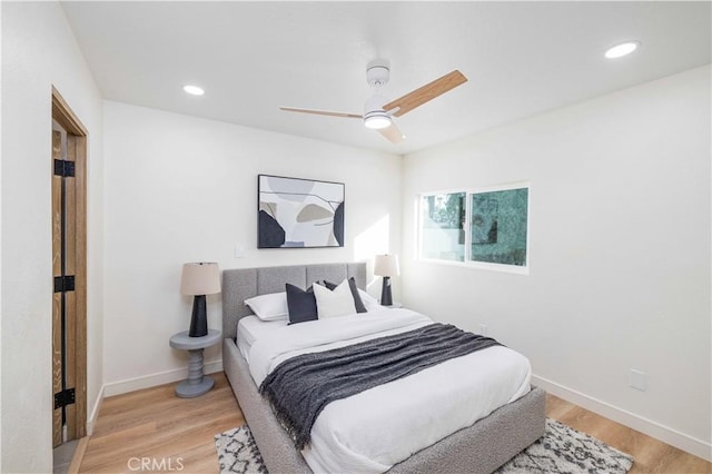 bedroom with ceiling fan and light hardwood / wood-style flooring