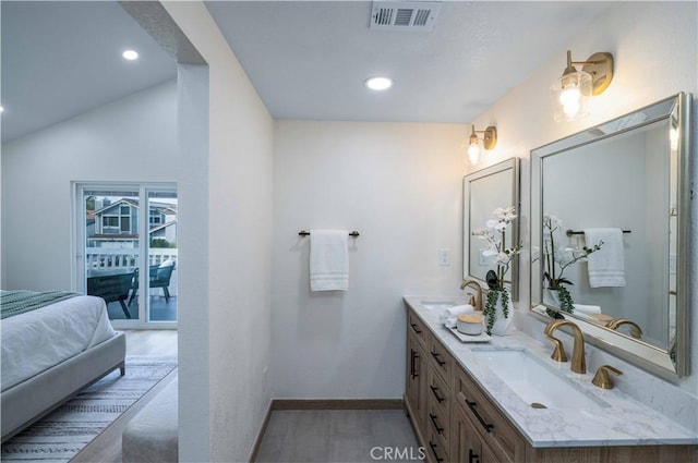 bathroom with vanity, vaulted ceiling, and wood-type flooring