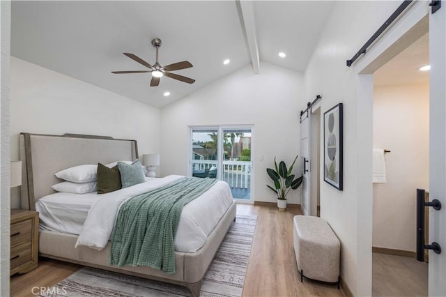 bedroom featuring beam ceiling, access to outside, ceiling fan, a barn door, and light hardwood / wood-style floors