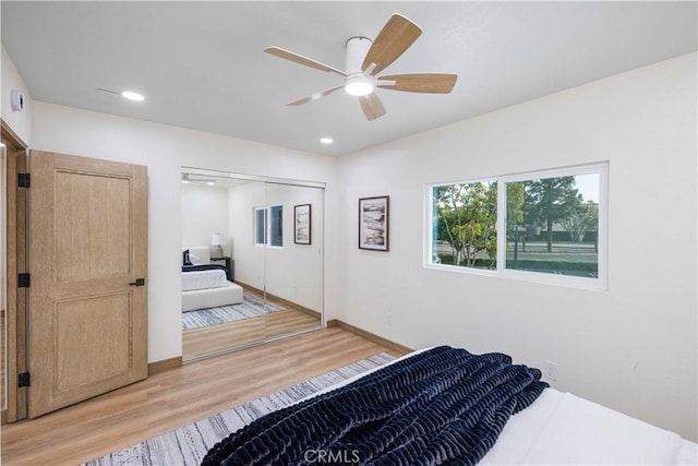 bedroom featuring hardwood / wood-style flooring, a closet, and ceiling fan