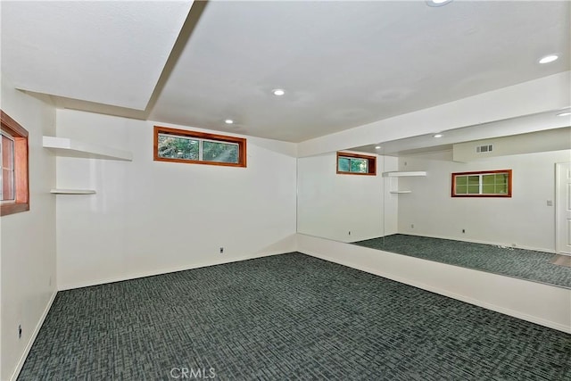 basement featuring dark colored carpet