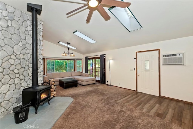 carpeted living room with ceiling fan, lofted ceiling, a wall mounted AC, and a wood stove