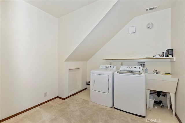 laundry room featuring separate washer and dryer and light colored carpet