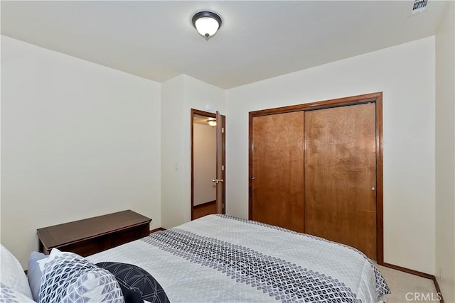 bedroom with light colored carpet and a closet