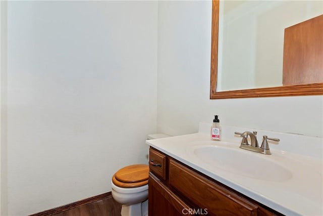 bathroom with vanity, hardwood / wood-style floors, and toilet