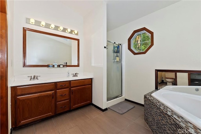 full bathroom featuring vanity, shower with separate bathtub, and toilet