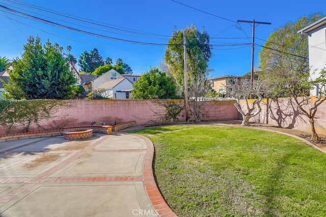 view of yard with a patio and a fire pit