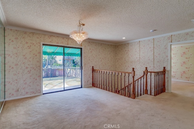 carpeted empty room with crown molding, an inviting chandelier, and a textured ceiling