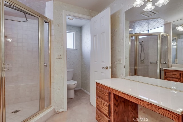 bathroom with vanity, toilet, and walk in shower