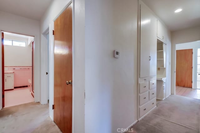 corridor featuring light colored carpet