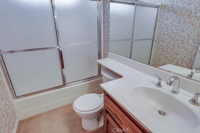 full bathroom featuring enclosed tub / shower combo, vanity, and toilet