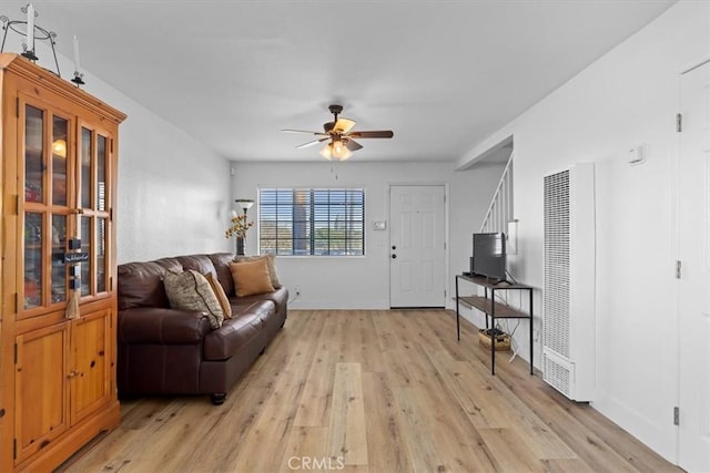 living room with ceiling fan and light wood-type flooring