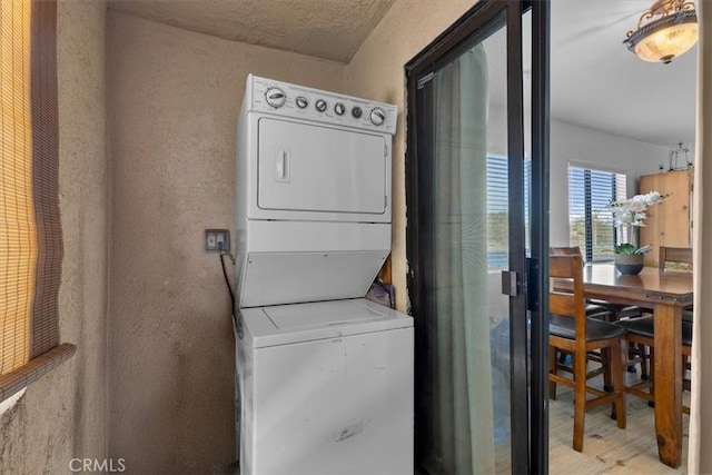 laundry area featuring stacked washer / dryer