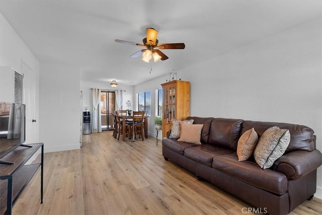 living room featuring light hardwood / wood-style floors and ceiling fan