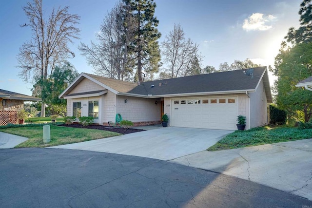 ranch-style home featuring a garage and a front lawn