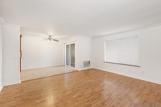 spare room featuring ceiling fan, ornamental molding, light hardwood / wood-style floors, and a wall unit AC