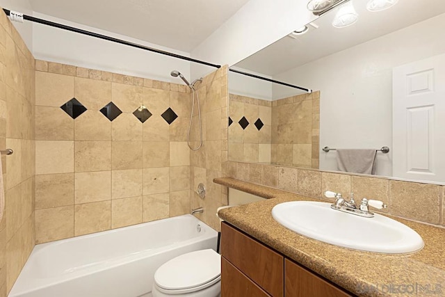 full bathroom featuring tiled shower / bath combo, toilet, vanity, and decorative backsplash