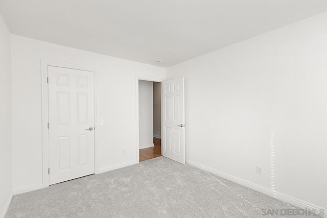 unfurnished bedroom featuring light colored carpet