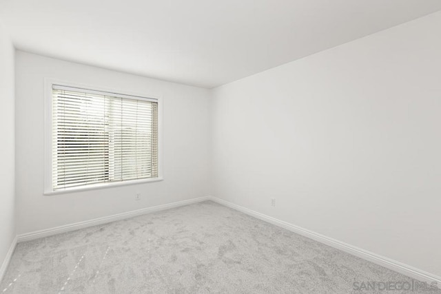 empty room featuring light colored carpet