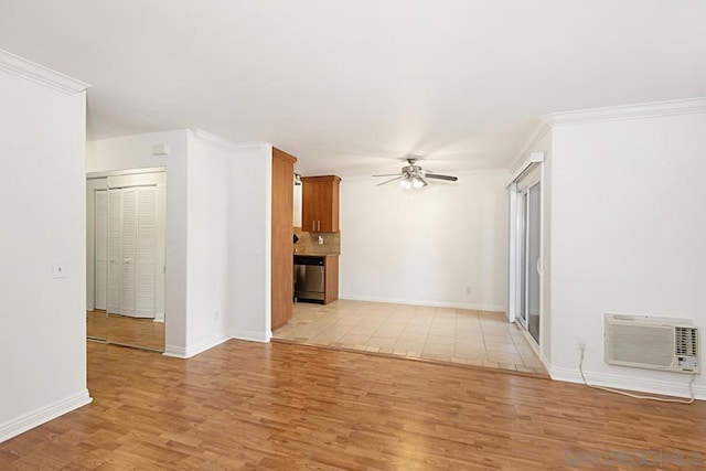 unfurnished living room featuring ceiling fan, a wall mounted air conditioner, ornamental molding, and light wood-type flooring