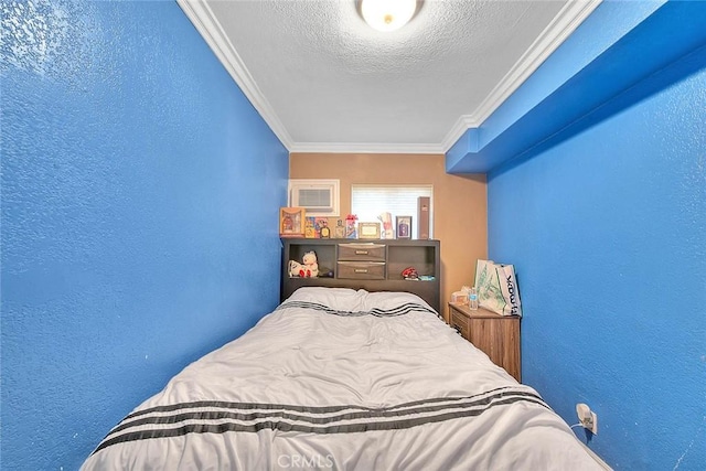 bedroom featuring crown molding and a textured ceiling