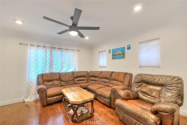 living room featuring hardwood / wood-style floors and ceiling fan