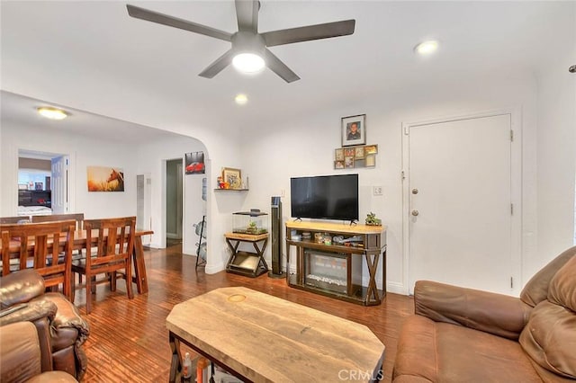 living room featuring hardwood / wood-style floors and ceiling fan