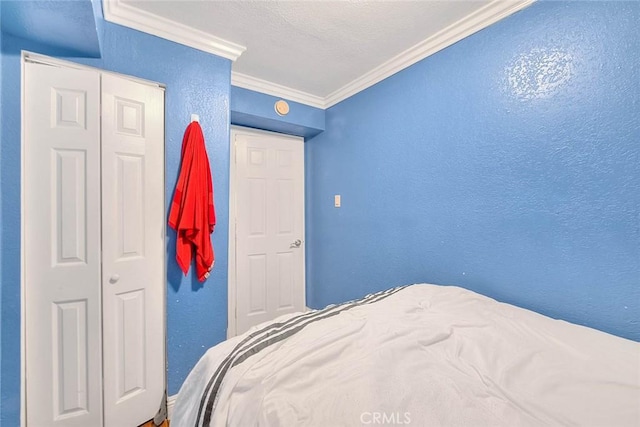 bedroom with ornamental molding and a closet