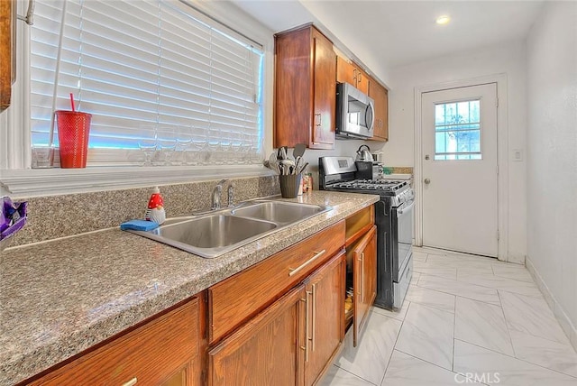 kitchen with sink and appliances with stainless steel finishes