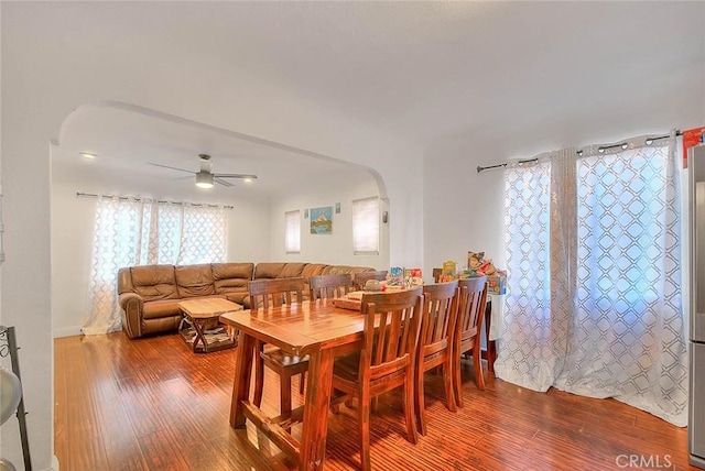 dining space featuring wood-type flooring and ceiling fan