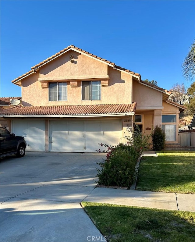 view of front of home featuring a garage and a front lawn