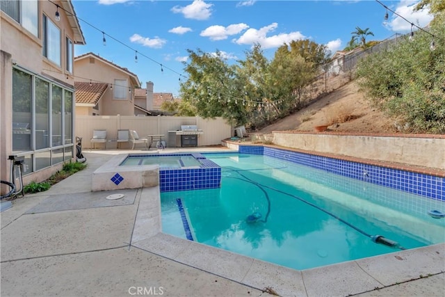 view of swimming pool with an in ground hot tub and a patio