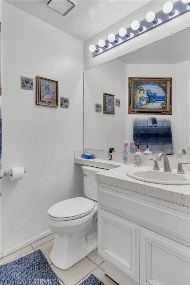 bathroom with tile patterned flooring, vanity, and toilet