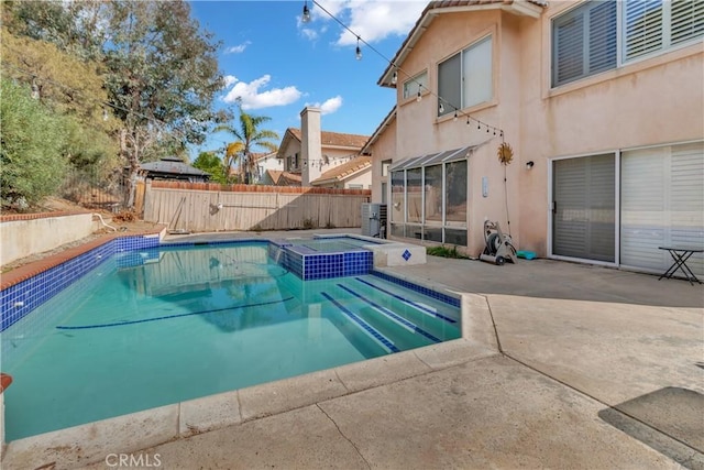 view of swimming pool with a patio area and an in ground hot tub