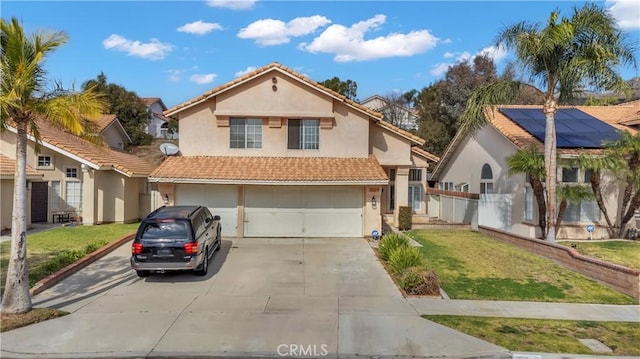 view of front of house with a garage, a front yard, and solar panels