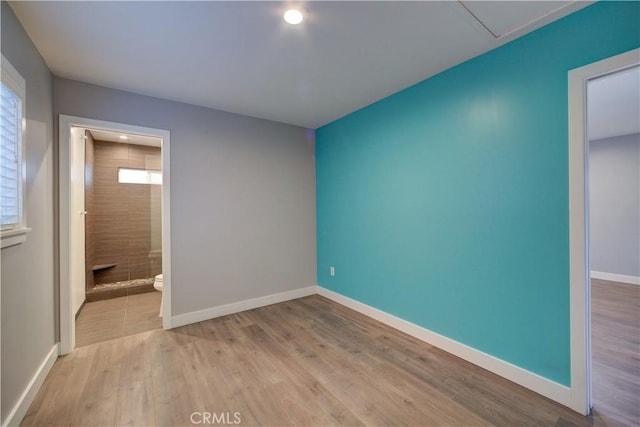 interior space with baseboards and wood finished floors