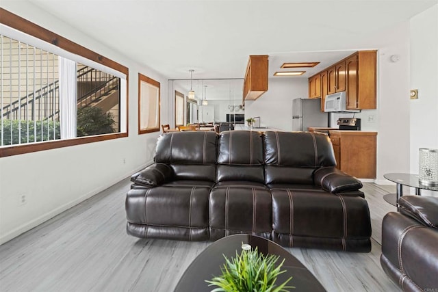 living room with sink and light wood-type flooring