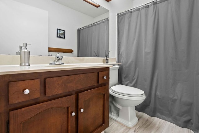 bathroom with vanity, wood-type flooring, toilet, and a shower with shower curtain