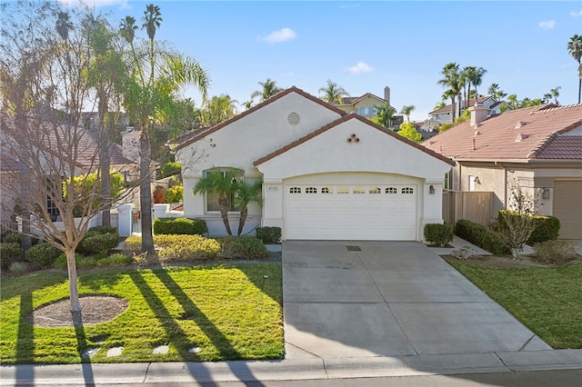 view of front of property featuring a garage and a front yard