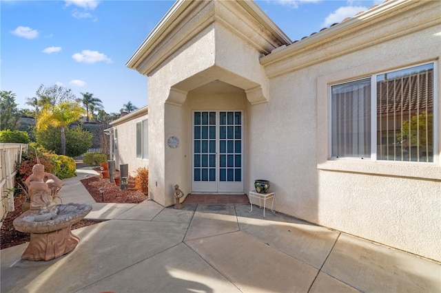 property entrance with a patio area