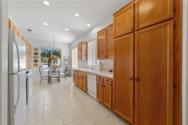 kitchen featuring light tile patterned flooring, sink, pendant lighting, and white appliances