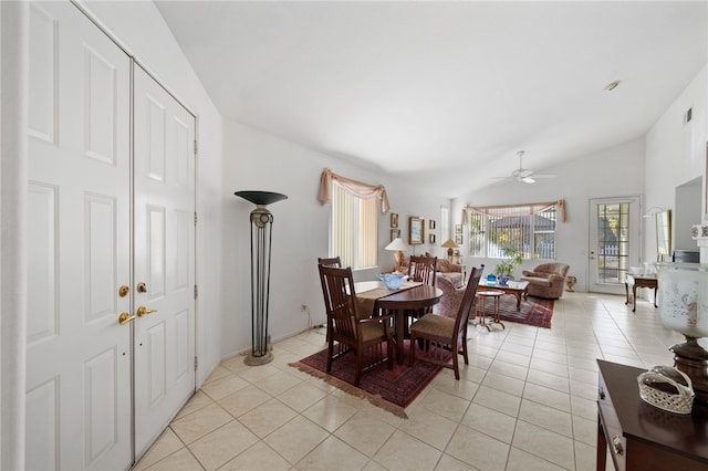 tiled dining space with ceiling fan and vaulted ceiling