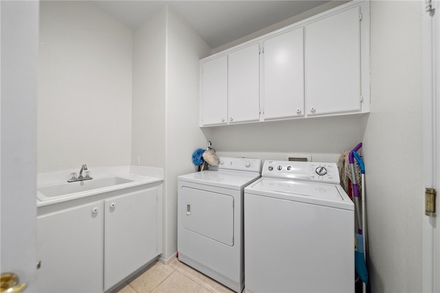 laundry area with cabinets, separate washer and dryer, sink, and light tile patterned floors