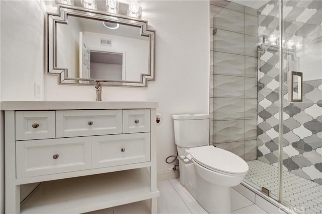 bathroom with visible vents, toilet, a stall shower, vanity, and baseboards