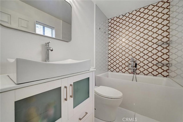 bathroom with vanity, toilet, and a bath